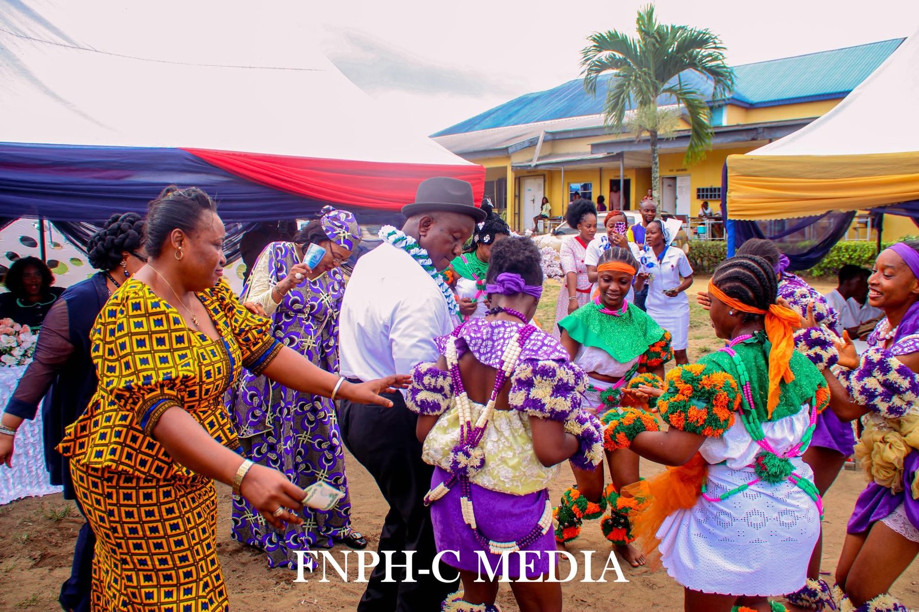 Celebration with a cultural dance troupe in front of the College building